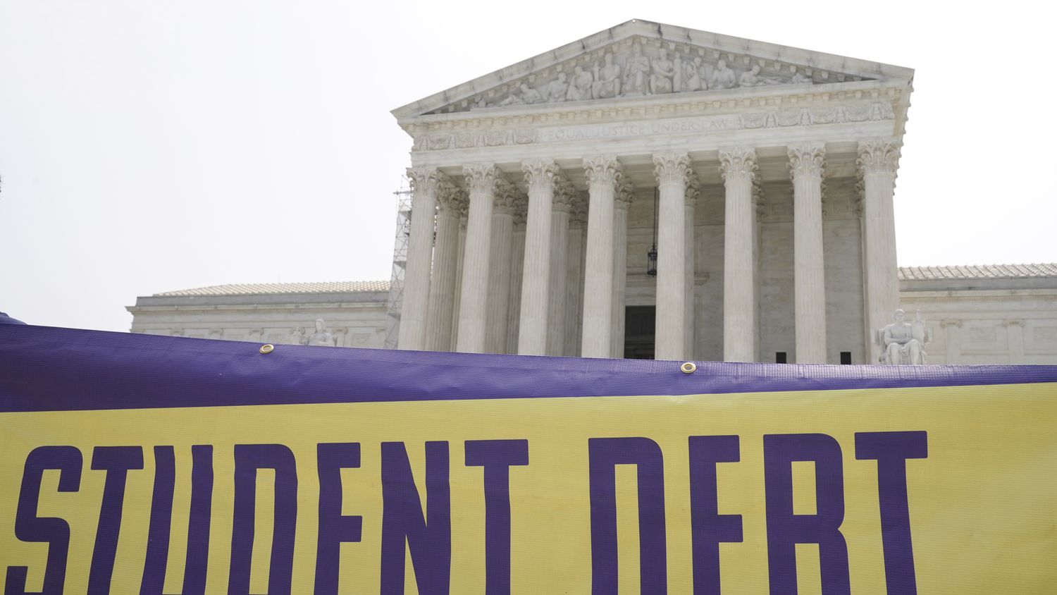 A sign reading "Student Debt" is seen outside the Supreme Court, Friday, June 30, 2023. A...