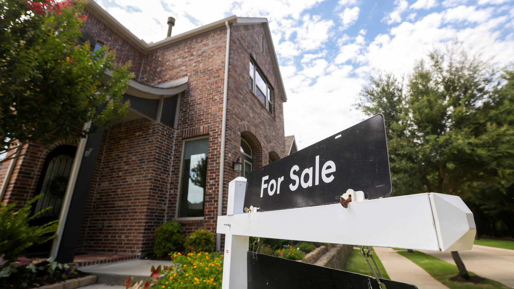 For Sale signs are posted in the front yards of homes of a Craig Ranch neighborhood in...