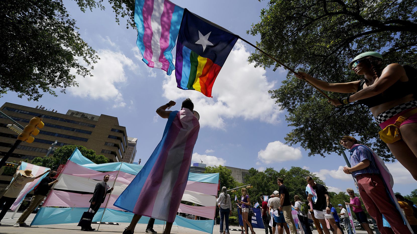 Demonstrators gather on the steps to the Texas Capitol to speak against transgender-related...